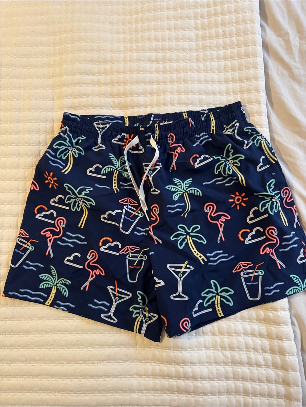 Chubbies Navy Swim Shorts with Neon Tropical Motifs